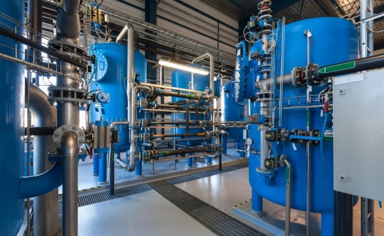 blue tanks and pipes in a chemical processing facility of some kind