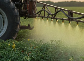 a tractor spraying pesticides